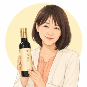 白い背景と淡い黄色の円の前で、白いジャケットとコーラル色のトップスを着た外園真紀さんが笑顔を見せ、金色のキャップが付いた黒い「RICCA」のボトルを両手で持っている人物イラストです。